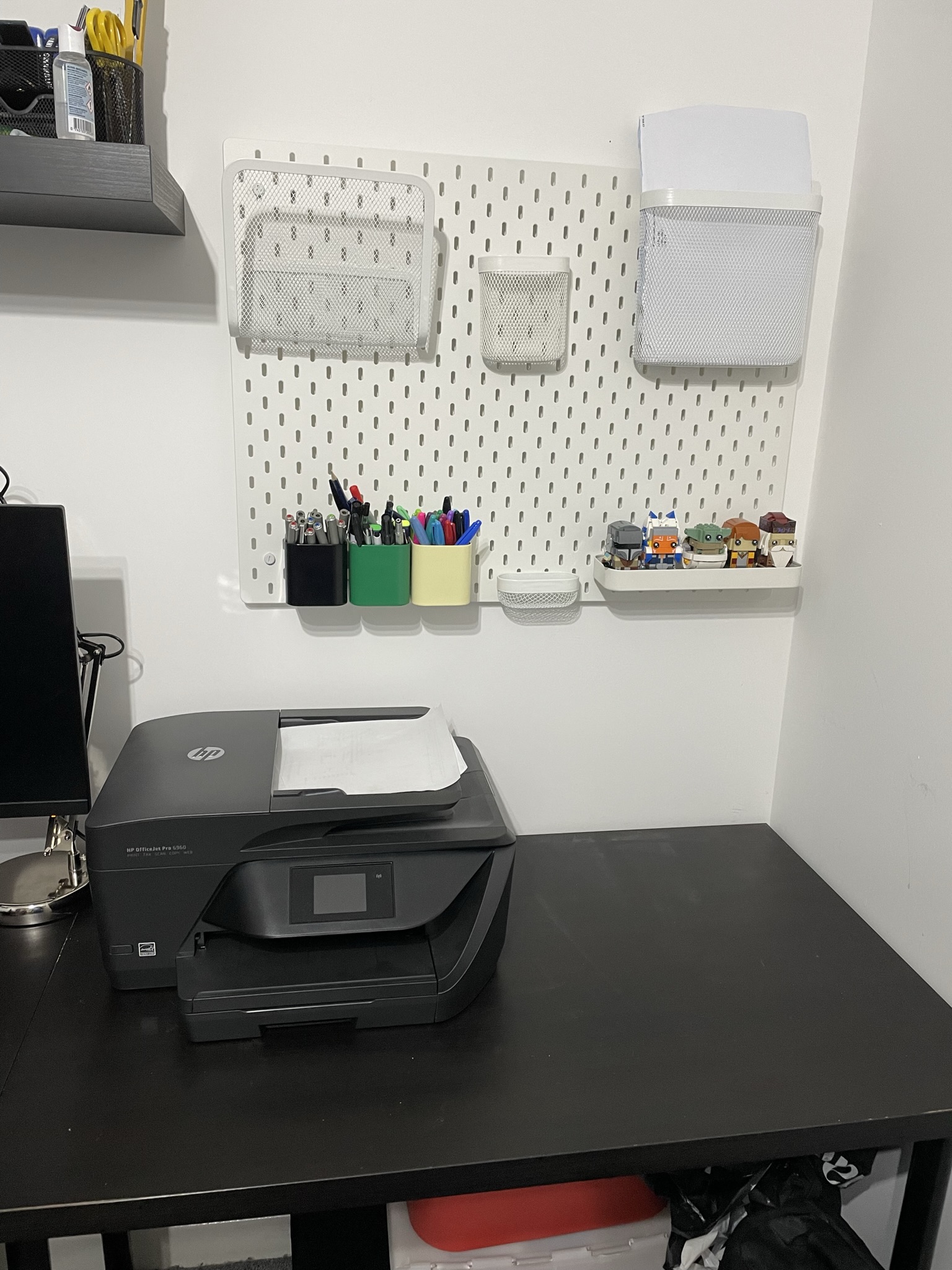 A desk space with IKEA pinboard and a printer